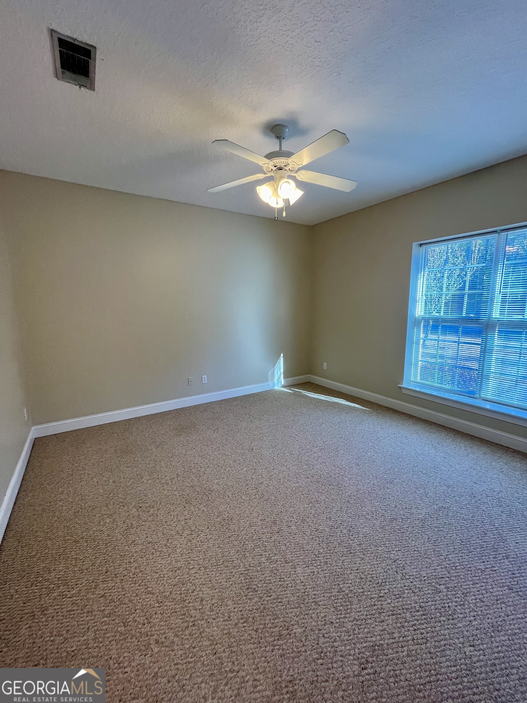 49 Coastal Walk St. Marys, GA 31558 - Photo 20 of 42 an empty room with windows and fan