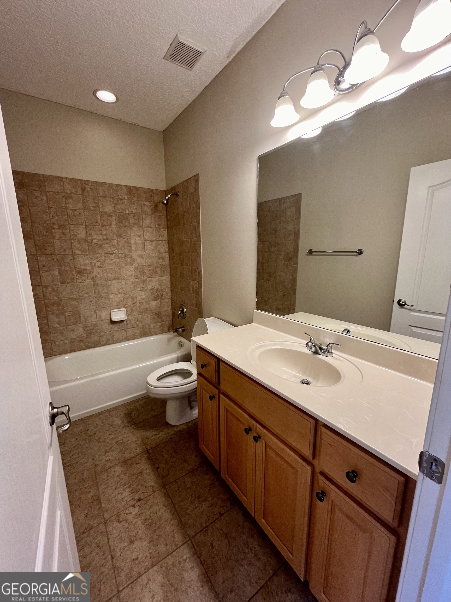 49 Coastal Walk St. Marys, GA 31558 - Photo 23 of 42 a bathroom with a double vanity sink toilet mirror and bathtub