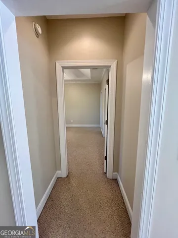 an empty room with a ceiling fan and window