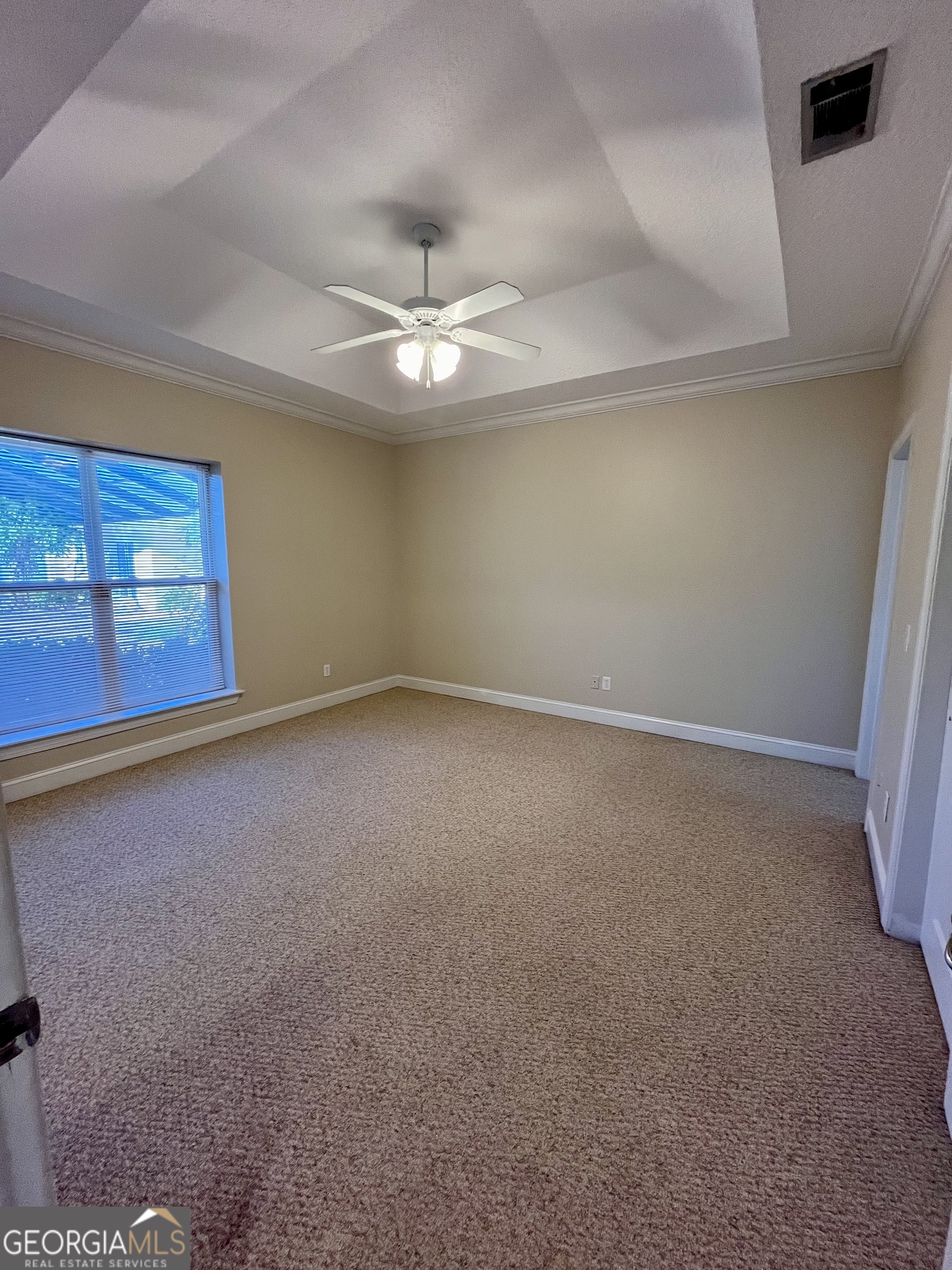 49 Coastal Walk St. Marys, GA 31558 - Photo 25 of 42 an empty room with a ceiling fan and window