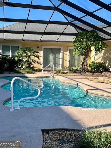 a view of a backyard with table and chairs under an umbrella