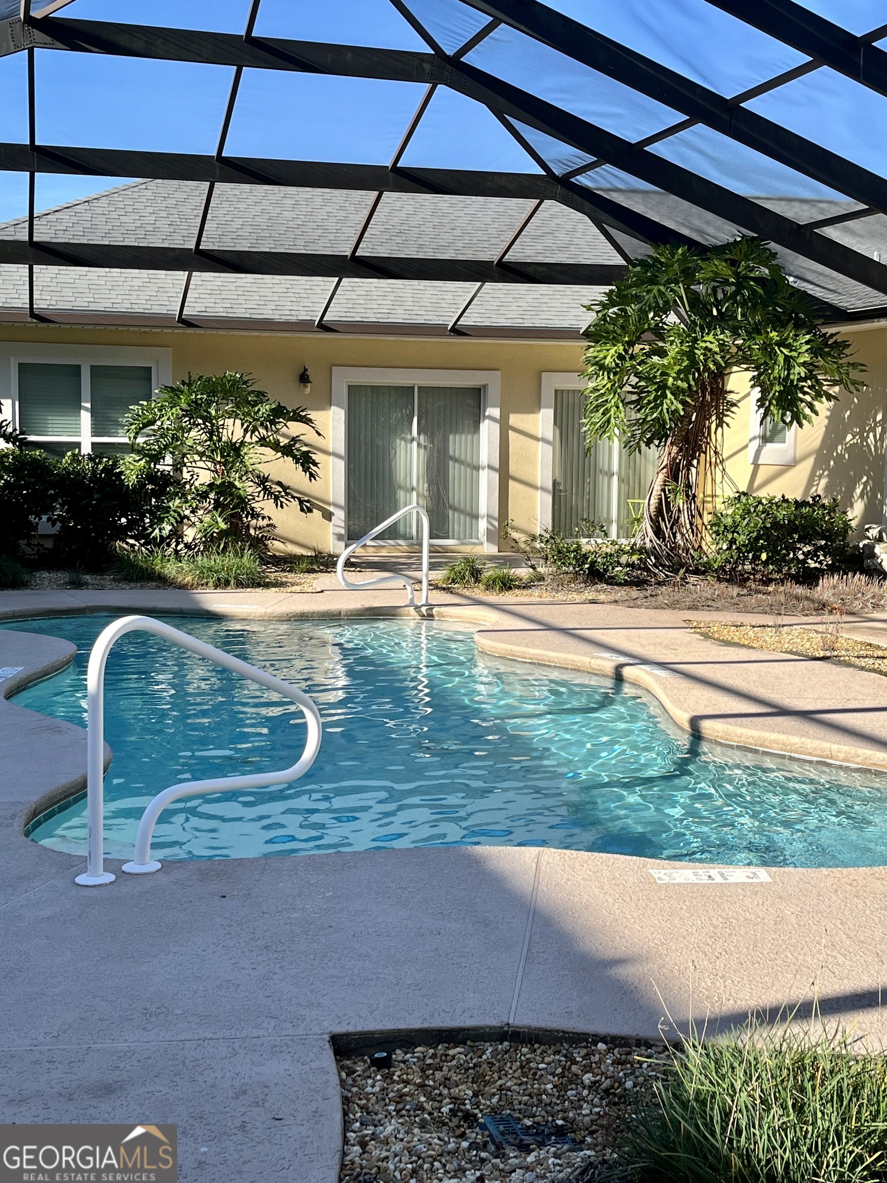 49 Coastal Walk St. Marys, GA 31558 - Photo 3 of 42 a view of a backyard with table and chairs under an umbrella