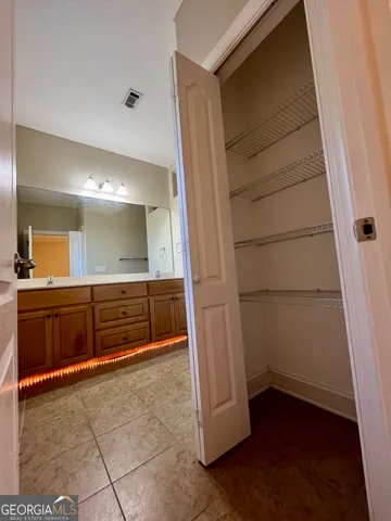 a bathroom with a mirror and a shower
