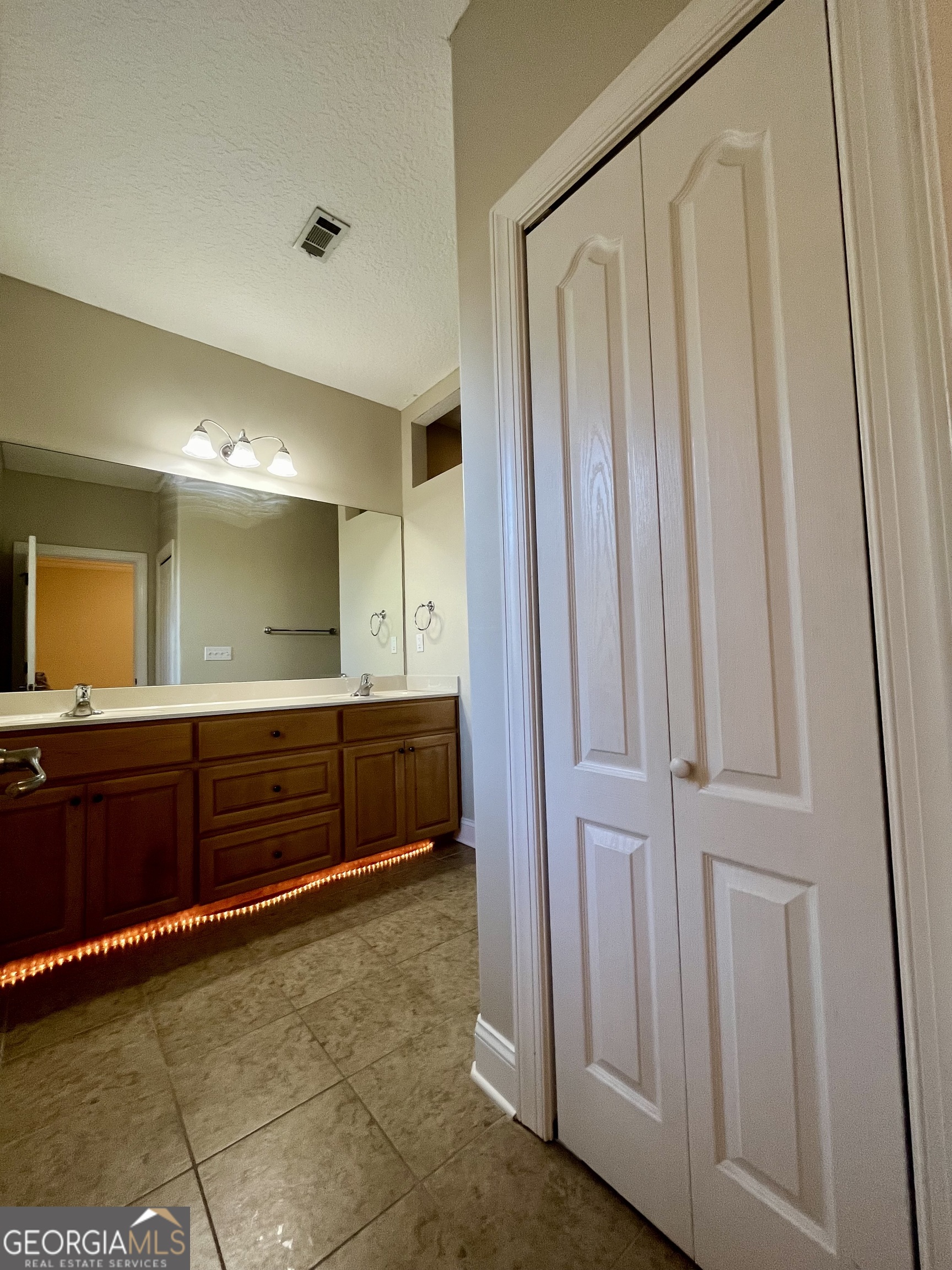 49 Coastal Walk St. Marys, GA 31558 - Photo 33 of 42 a bathroom with a mirror and a shower