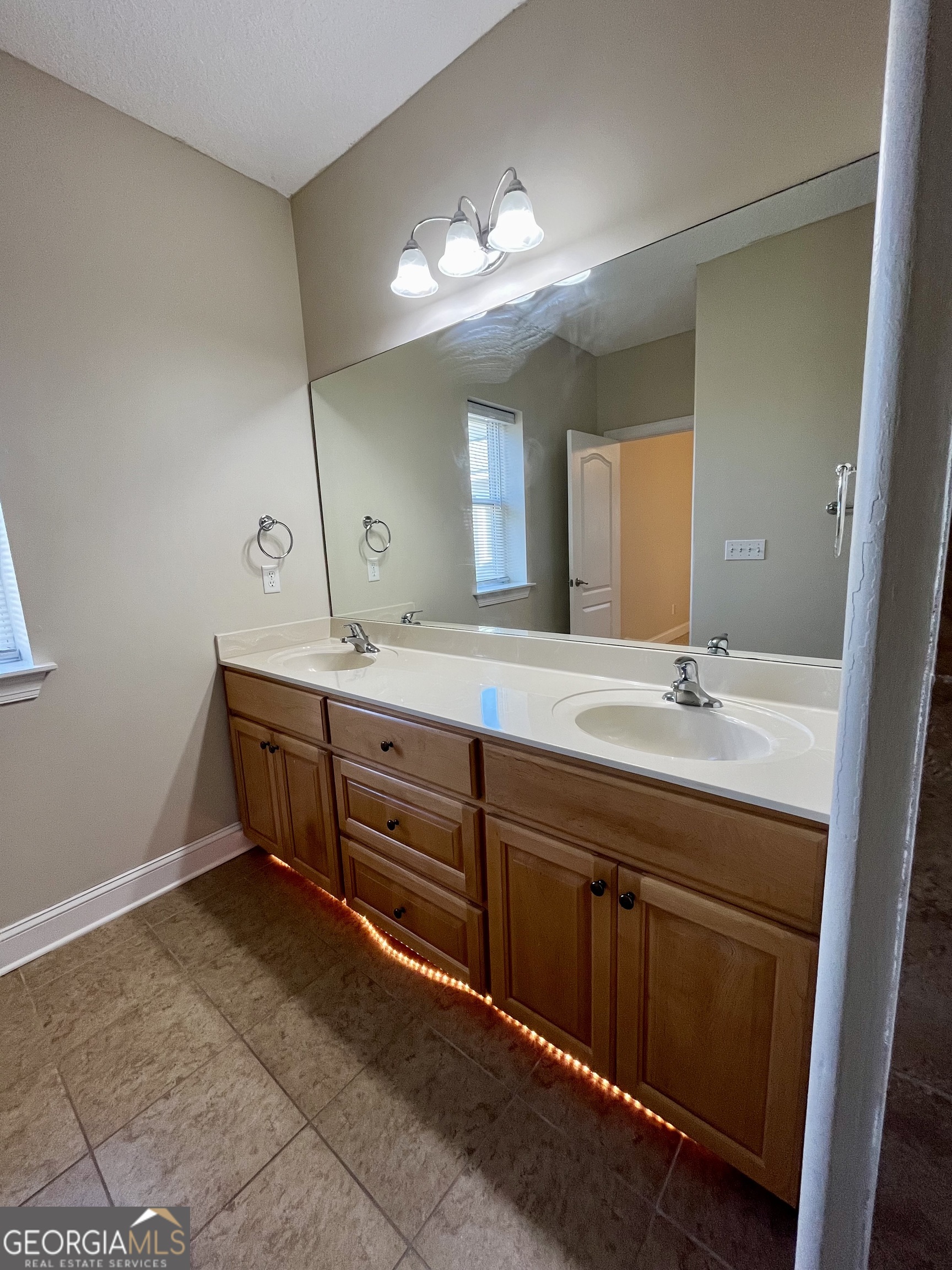 49 Coastal Walk St. Marys, GA 31558 - Photo 36 of 42 a spacious bathroom with a granite countertop sink a toilet and a mirror