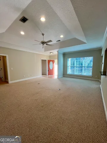 a view of an empty room with a windows