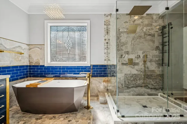 a bathroom with a bathtub and shower