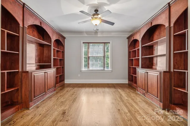 a view of a kitchen with furniture cabinets and wooden floor