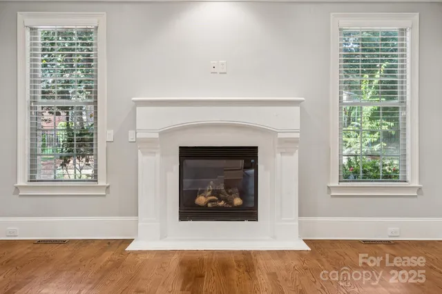 a living room with a fireplace and a window