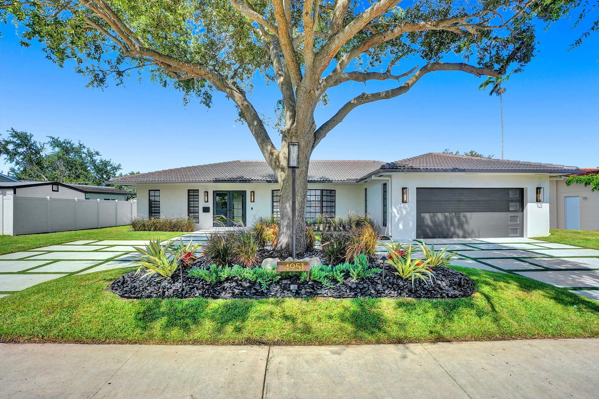 4951 Sarazen Drive Hollywood, FL 33021 - Photo 2 of 21 a front view of a house with a yard