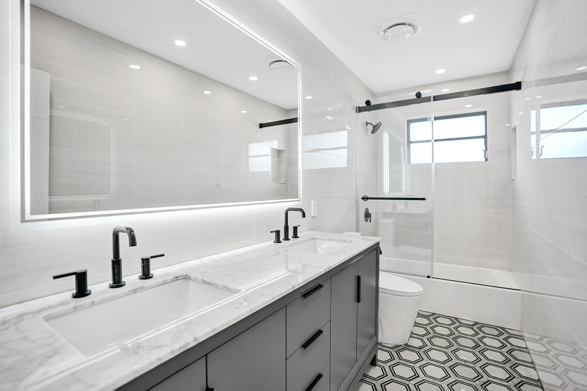 4951 Sarazen Drive Hollywood, FL 33021 - Photo 5 of 21 a bathroom with a double vanity sink a and mirror