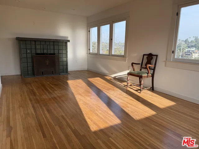a spacious bedroom with a bed and a window