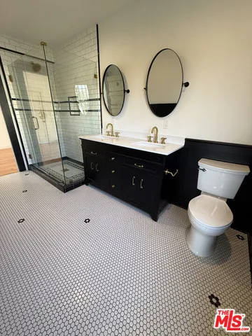 a bathroom with a sink mirror vanity and toilet