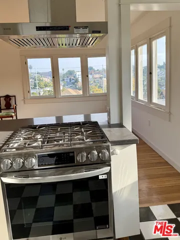 a view of a stove top oven and sitting area