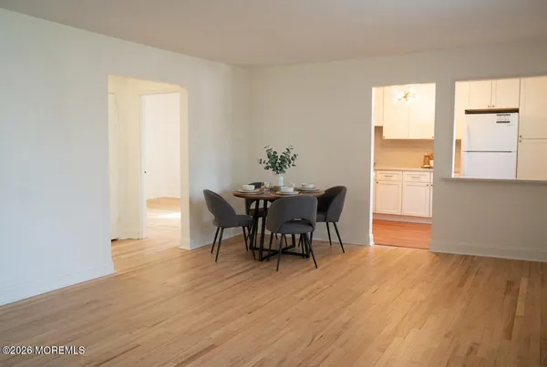 a dining room with furniture and wooden floor