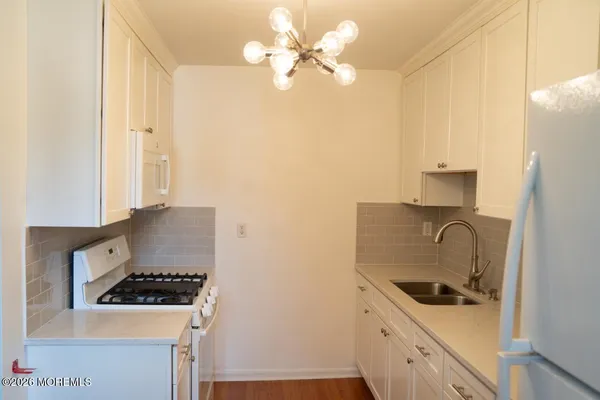 a kitchen with stainless steel appliances a stove a sink and a refrigerator