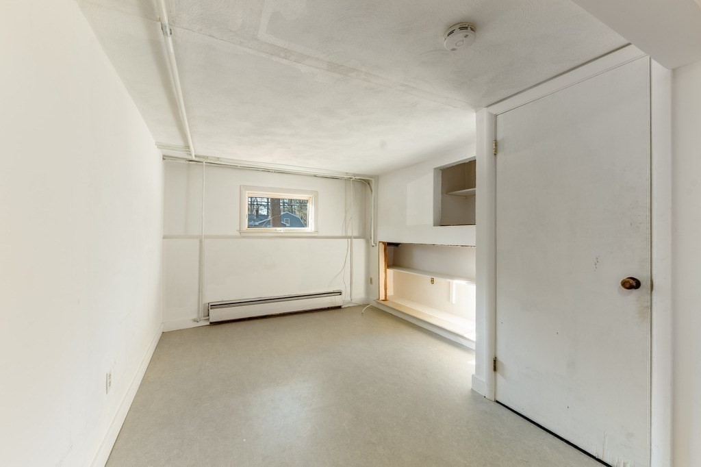 250 Hudson Road Sudbury, MA 01776 - Photo 13 of 19 a view of an empty room with a window and kitchen