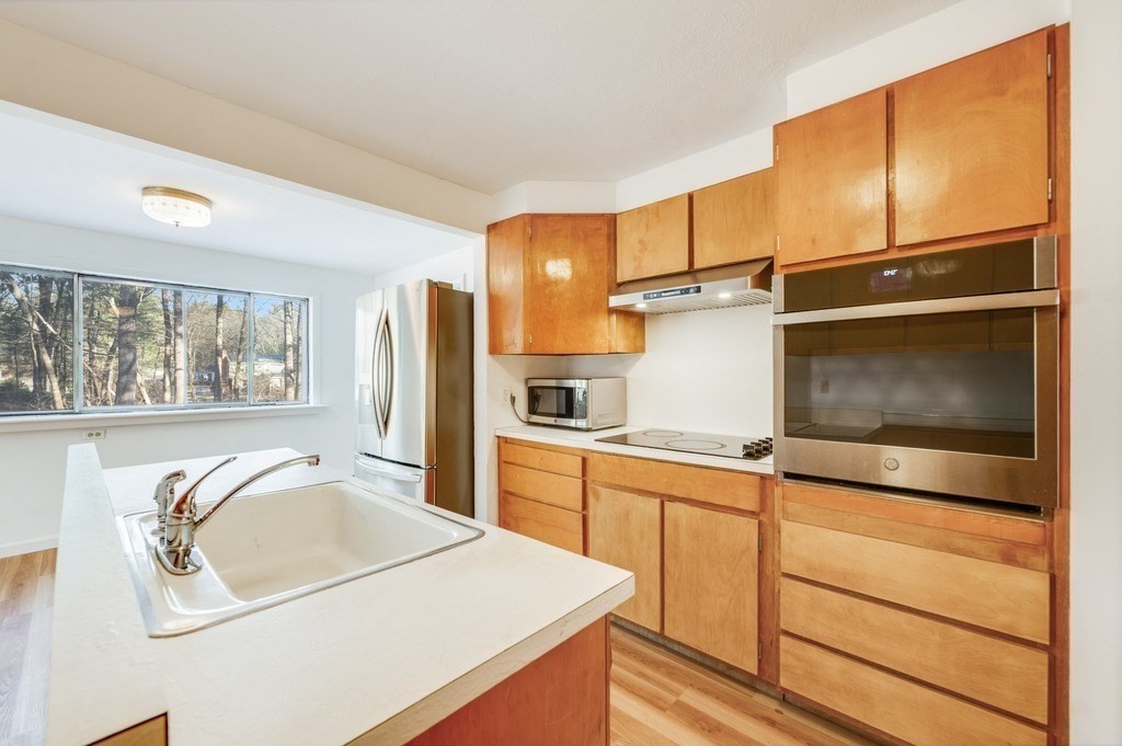 250 Hudson Road Sudbury, MA 01776 - Photo 4 of 19 a kitchen with a refrigerator sink and cabinets