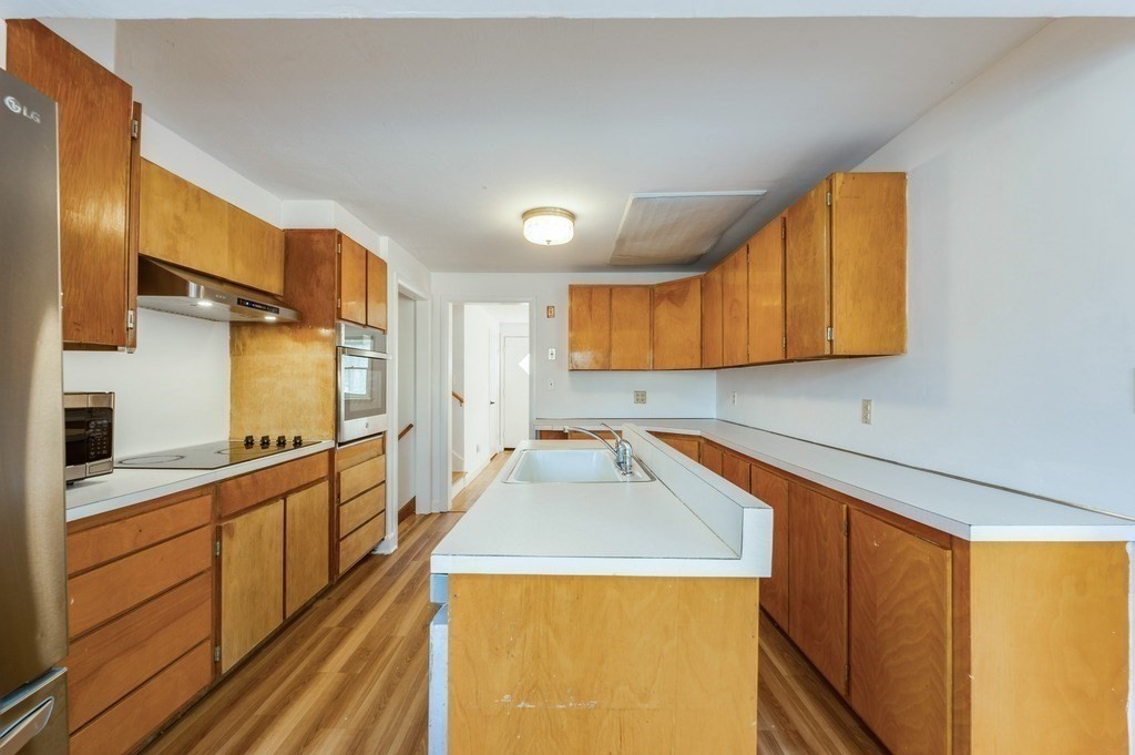 250 Hudson Road Sudbury, MA 01776 - Photo 5 of 19 a kitchen that has a sink and a stove in it