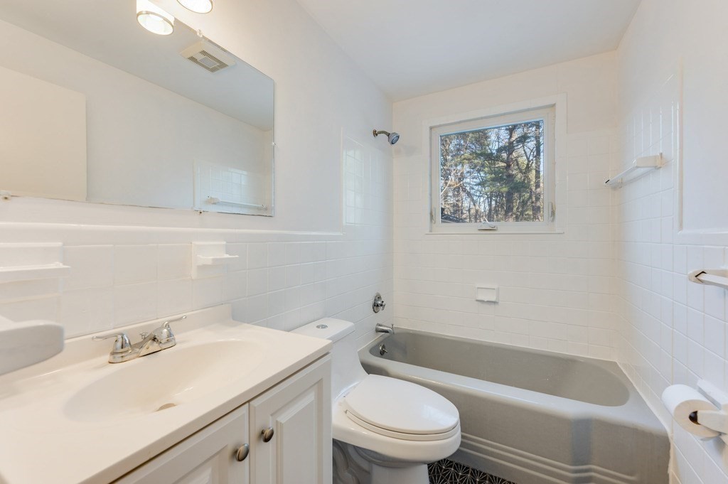 250 Hudson Road Sudbury, MA 01776 - Photo 9 of 19 a bathroom with a sink a toilet and bathtub