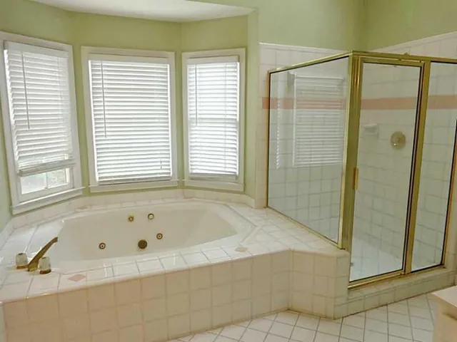 a bathroom with a bathtub and shower