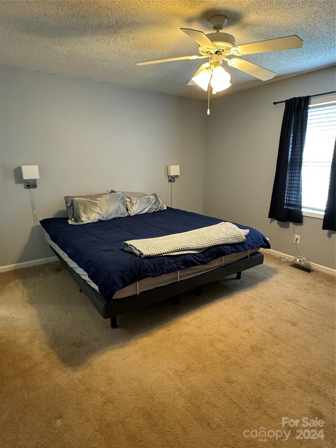 445 Stone Road Salisbury, NC 28146 - Photo 6 of 22 a bedroom with a bed and a chandelier