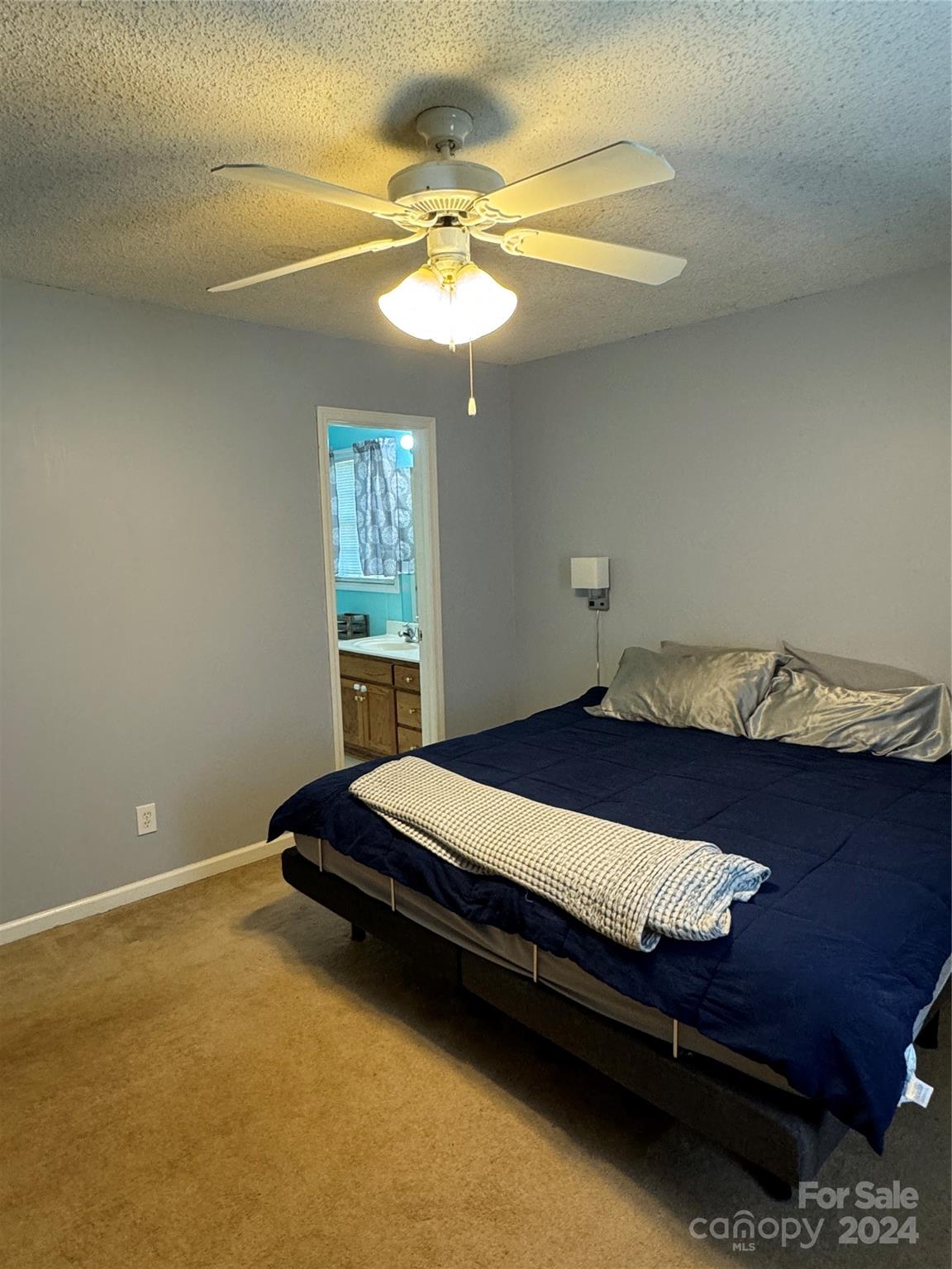 445 Stone Road Salisbury, NC 28146 - Photo 8 of 22 a bedroom with a bed and a chandelier