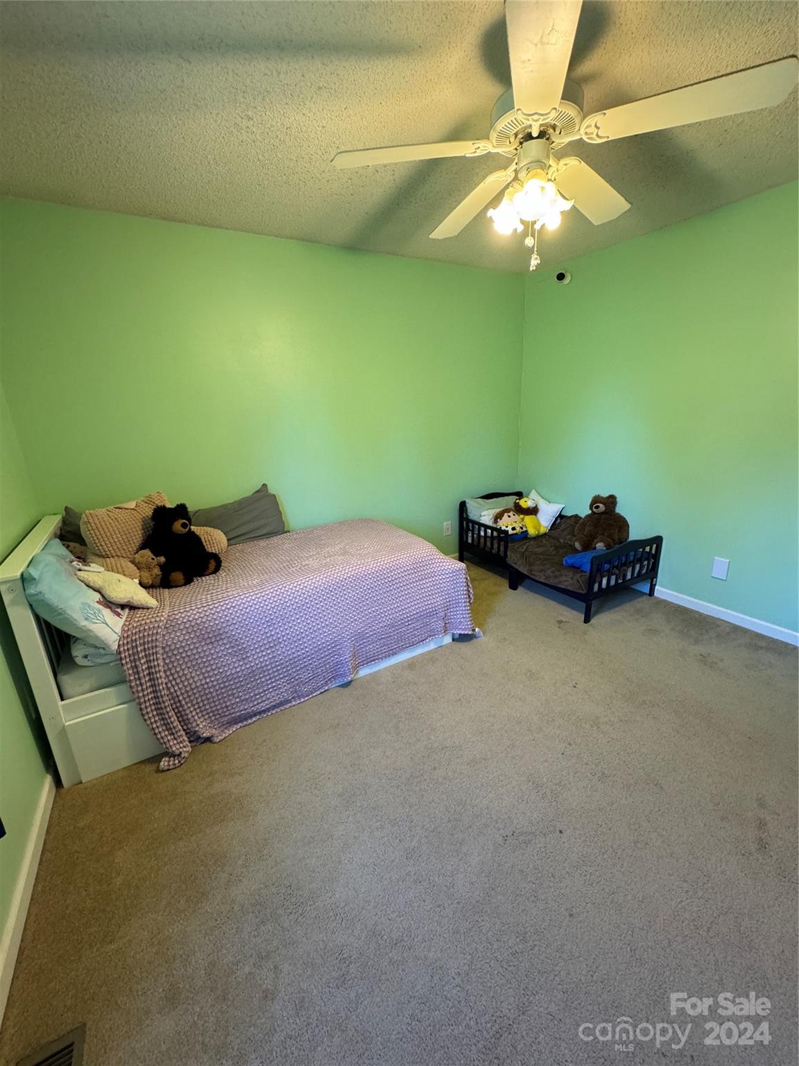 445 Stone Road Salisbury, NC 28146 - Photo 10 of 22 a bedroom with a bed and a chandelier