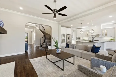a living room with furniture and kitchen view