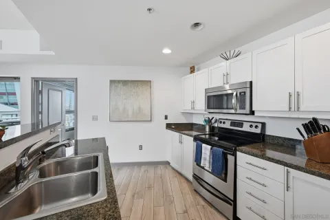 a kitchen that has a sink and a stove top oven