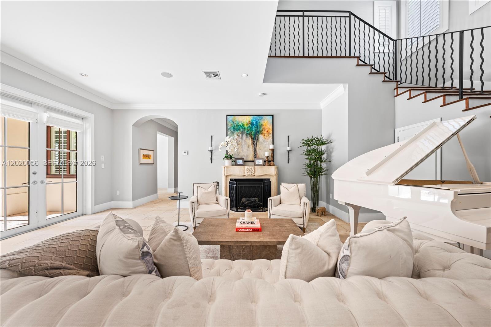 4196 Douglas Road Miami, FL 33133 - Photo 20 of 96 a living room with furniture a fireplace and a flat screen tv