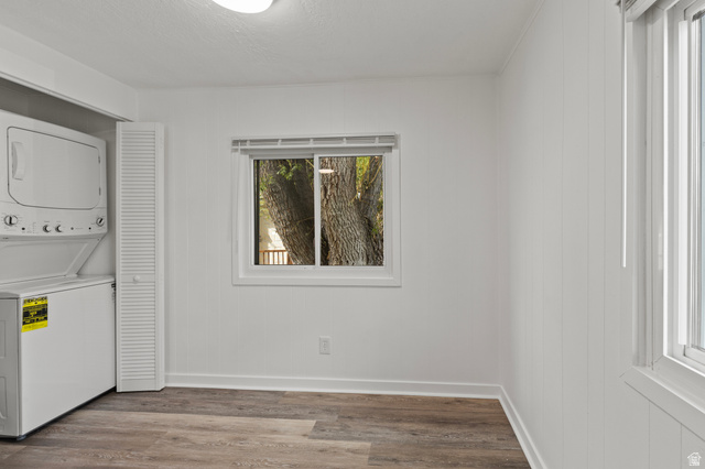 350 West 800 South, Unit 2 Logan, UT 84321 - Photo 6 of 22 Laundry area with stacked washer and clothes dryer and wood finished floors