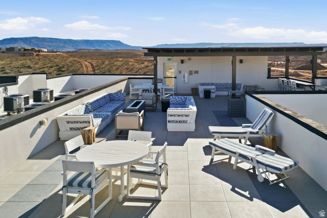 961 West Akoya Pearl Road, Unit 300 St. George, UT 84790 - Photo 50 of 60 View of patio featuring a mountain view, an outdoor fire pit, and an outdoor living / dining area