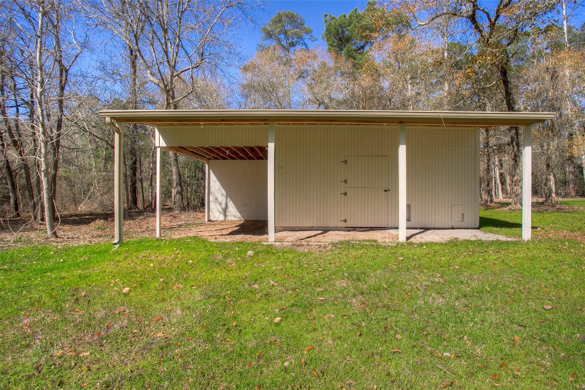 83 Dahlia Road Huntsville, TX 77320 - Photo 47 of 49 a view of a house with backyard