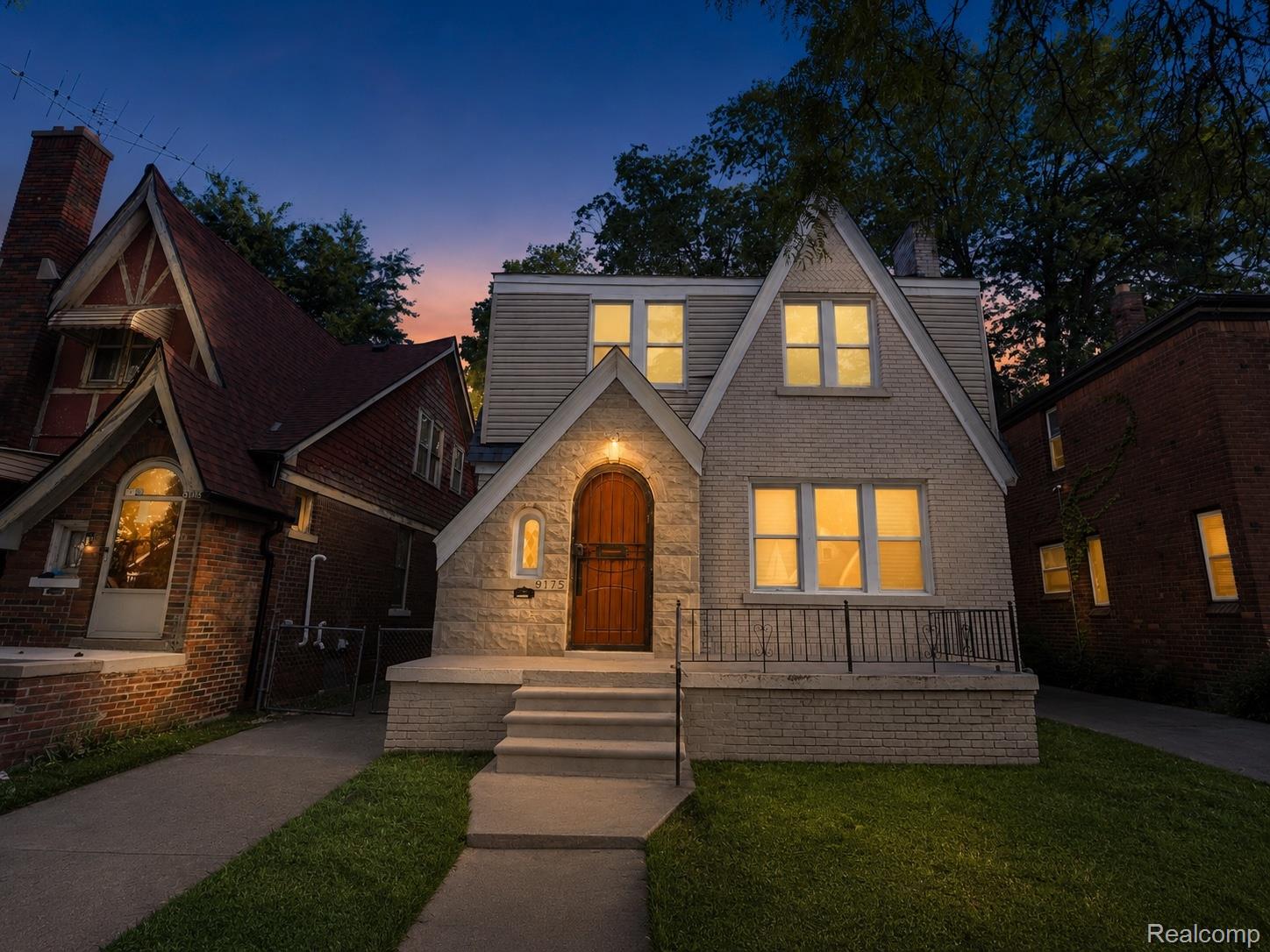 9175 Devonshire Road Detroit, MI 48224 - Photo 23 of 23 Gable-front home featuring a striking arched solid wood door with a decorative security gate