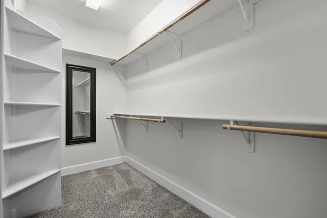 a view of a dining room with a table and chairs