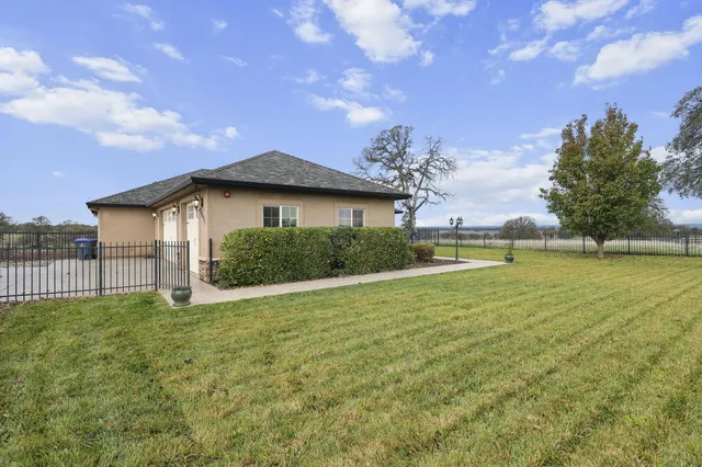an aerial view of residential houses with outdoor space and trees