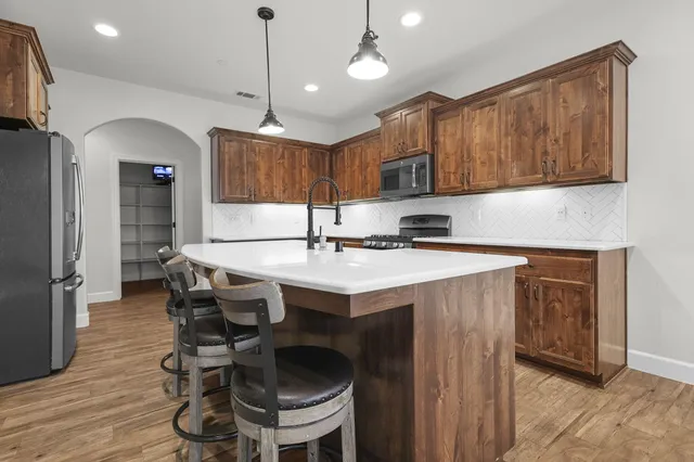 a living room with furniture a fireplace and a large window
