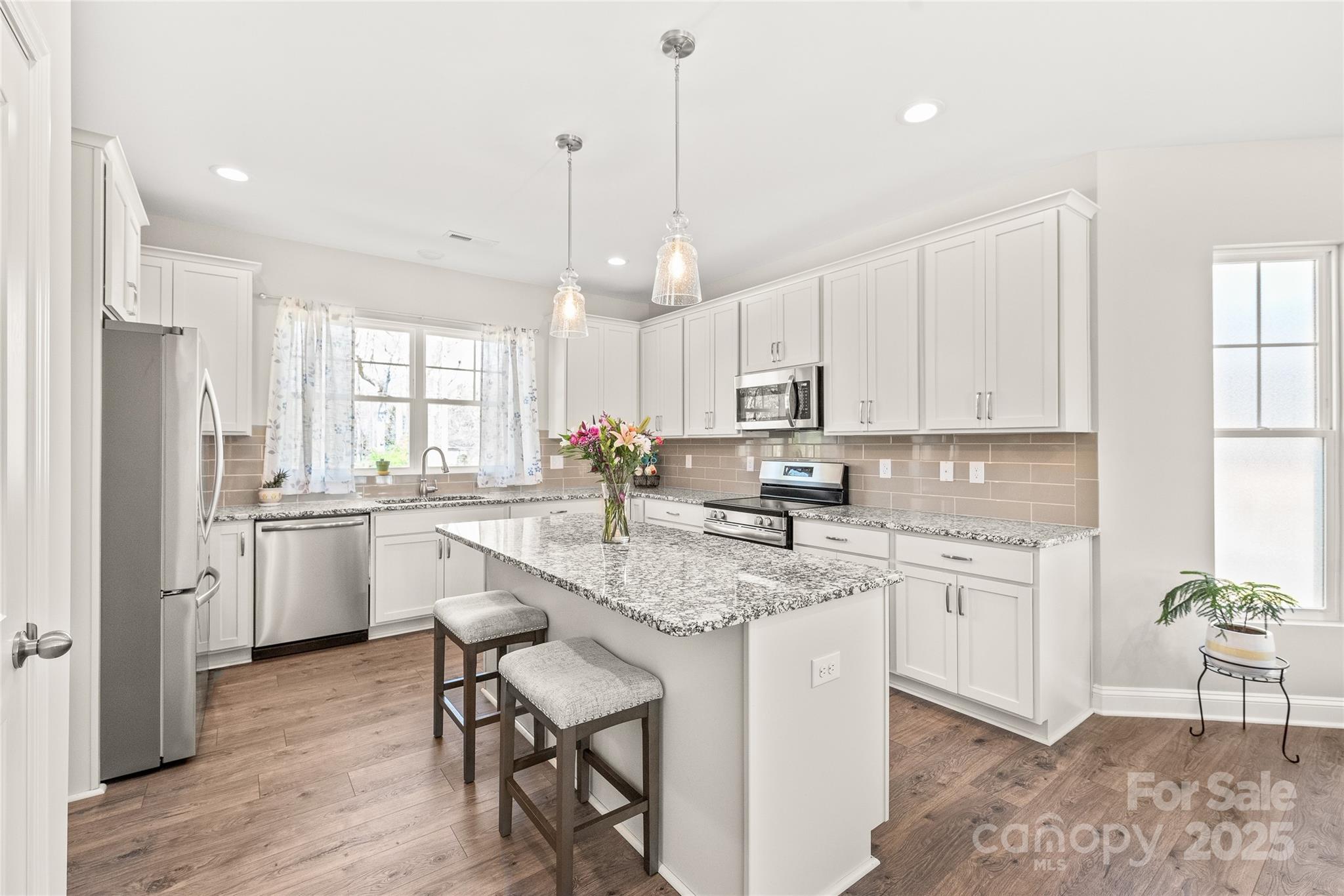a kitchen with white cabinets and white appliances