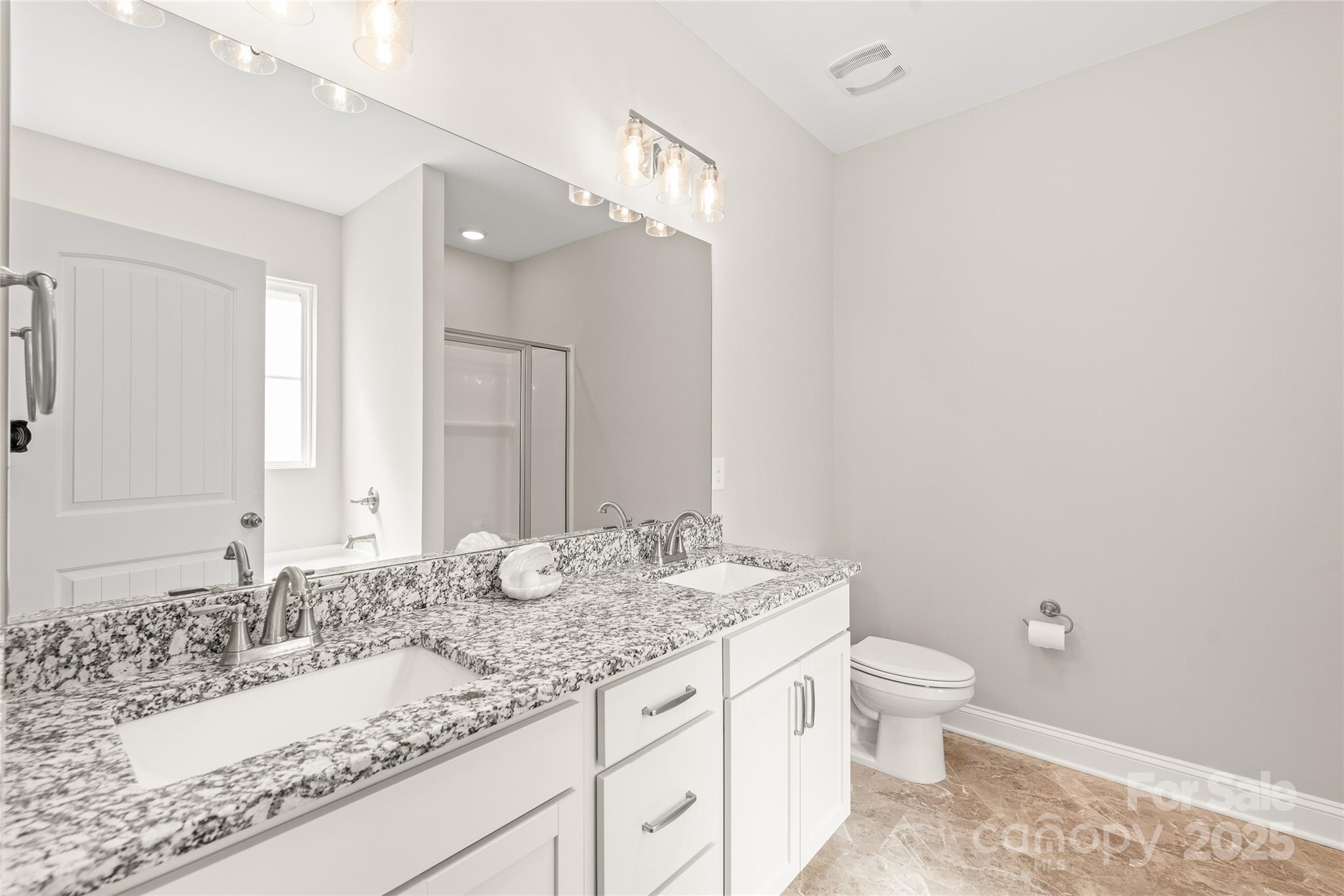 2116 Wilson Avenue Monroe, NC 28110 - Photo 11 of 21 a bathroom with a granite countertop sink a toilet and a mirror