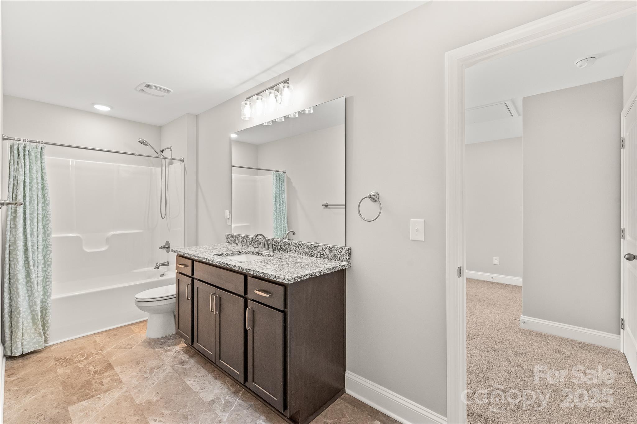 2116 Wilson Avenue Monroe, NC 28110 - Photo 13 of 21 a bathroom with a granite countertop sink a toilet and shower