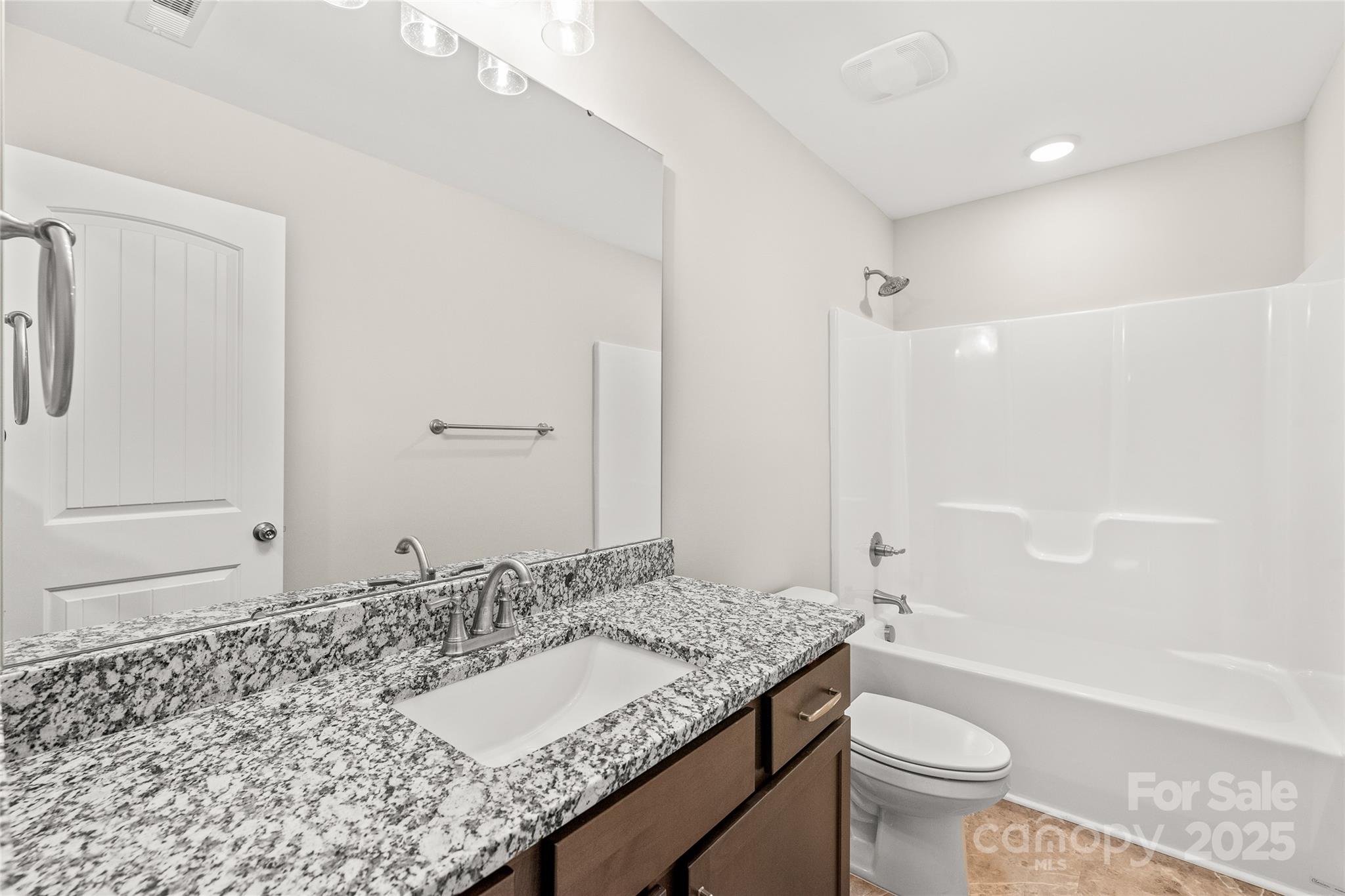2116 Wilson Avenue Monroe, NC 28110 - Photo 17 of 21 a bathroom with a granite countertop sink toilet and shower