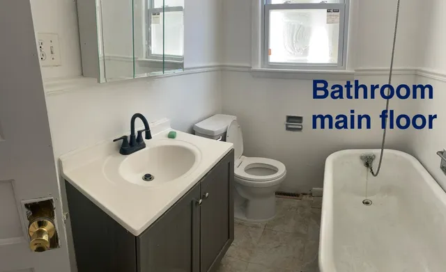 a bathroom with a toilet sink and mirror
