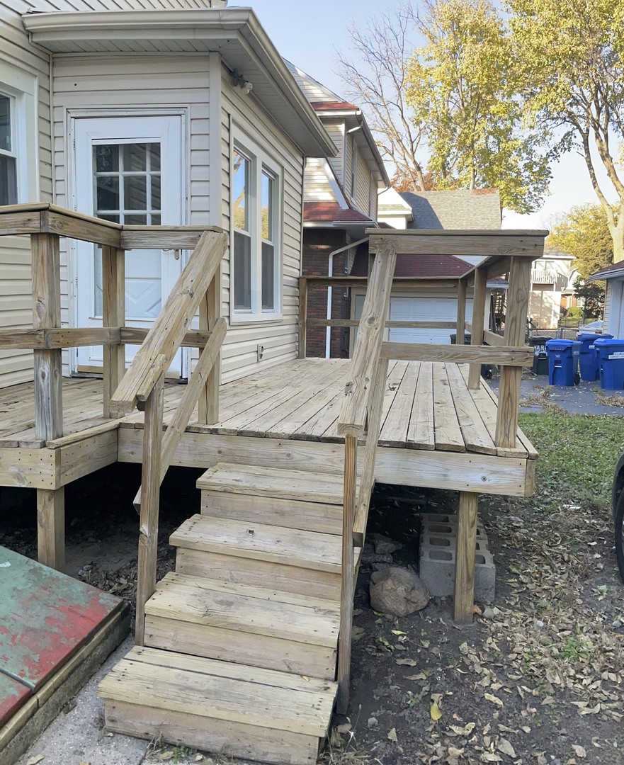 136 John Street DeKalb, IL 60115 - Photo 2 of 19 a view of a house with large windows and a table and chairs