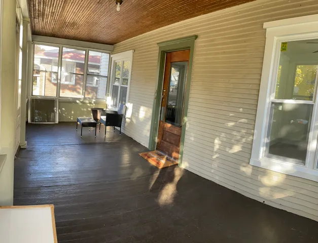 a view of dining room with floor to ceiling window and wooden floor