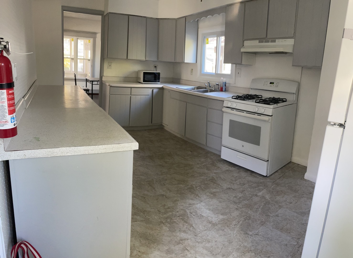 136 John Street DeKalb, IL 60115 - Photo 5 of 19 a kitchen with cabinets appliances and a window