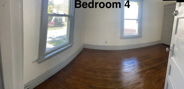 an entryway with wooden floor and windows