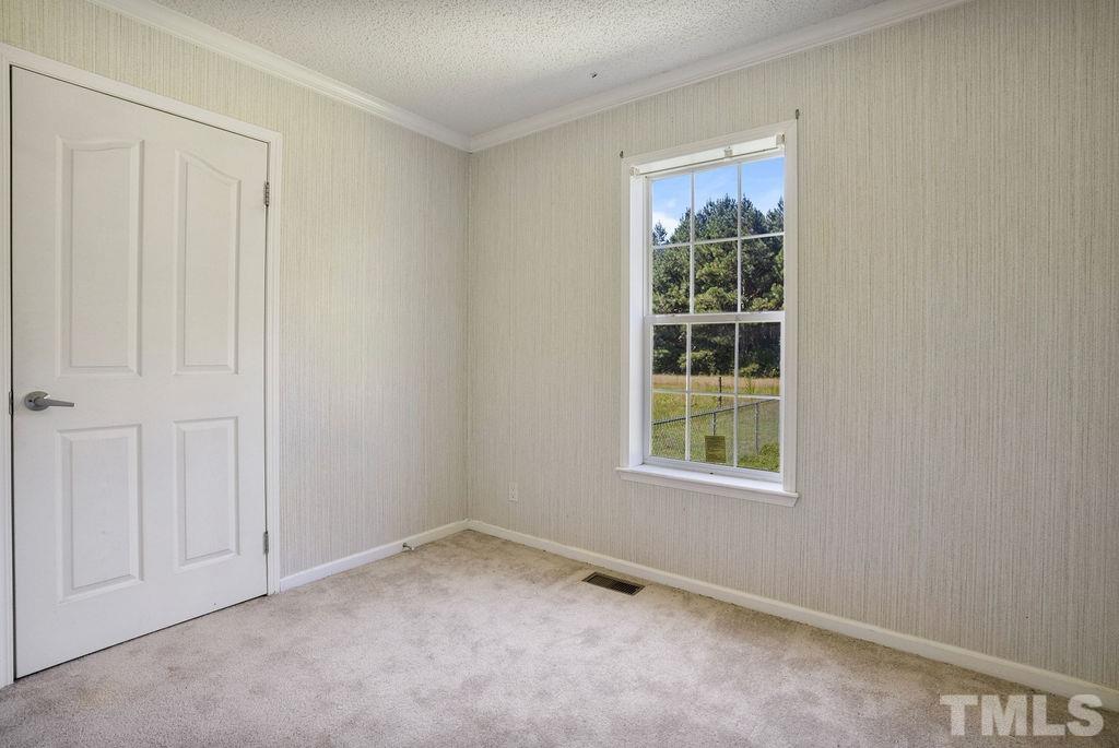 92 Wayland Drive St. Pauls, NC 28384 - Photo 13 of 36 an empty room with a window
