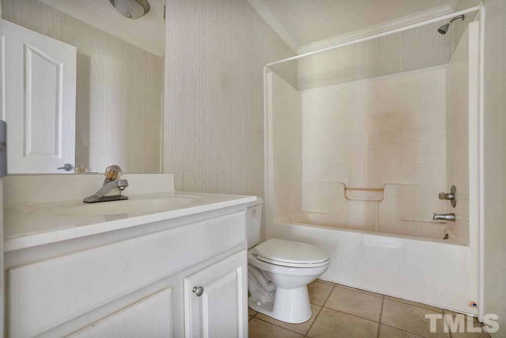 92 Wayland Drive St. Pauls, NC 28384 - Photo 14 of 36 a bathroom with a sink a toilet and shower