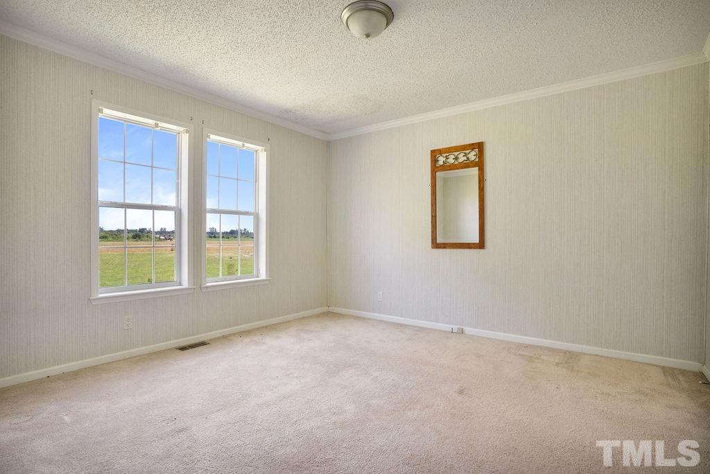 92 Wayland Drive St. Pauls, NC 28384 - Photo 16 of 36 an empty room with windows